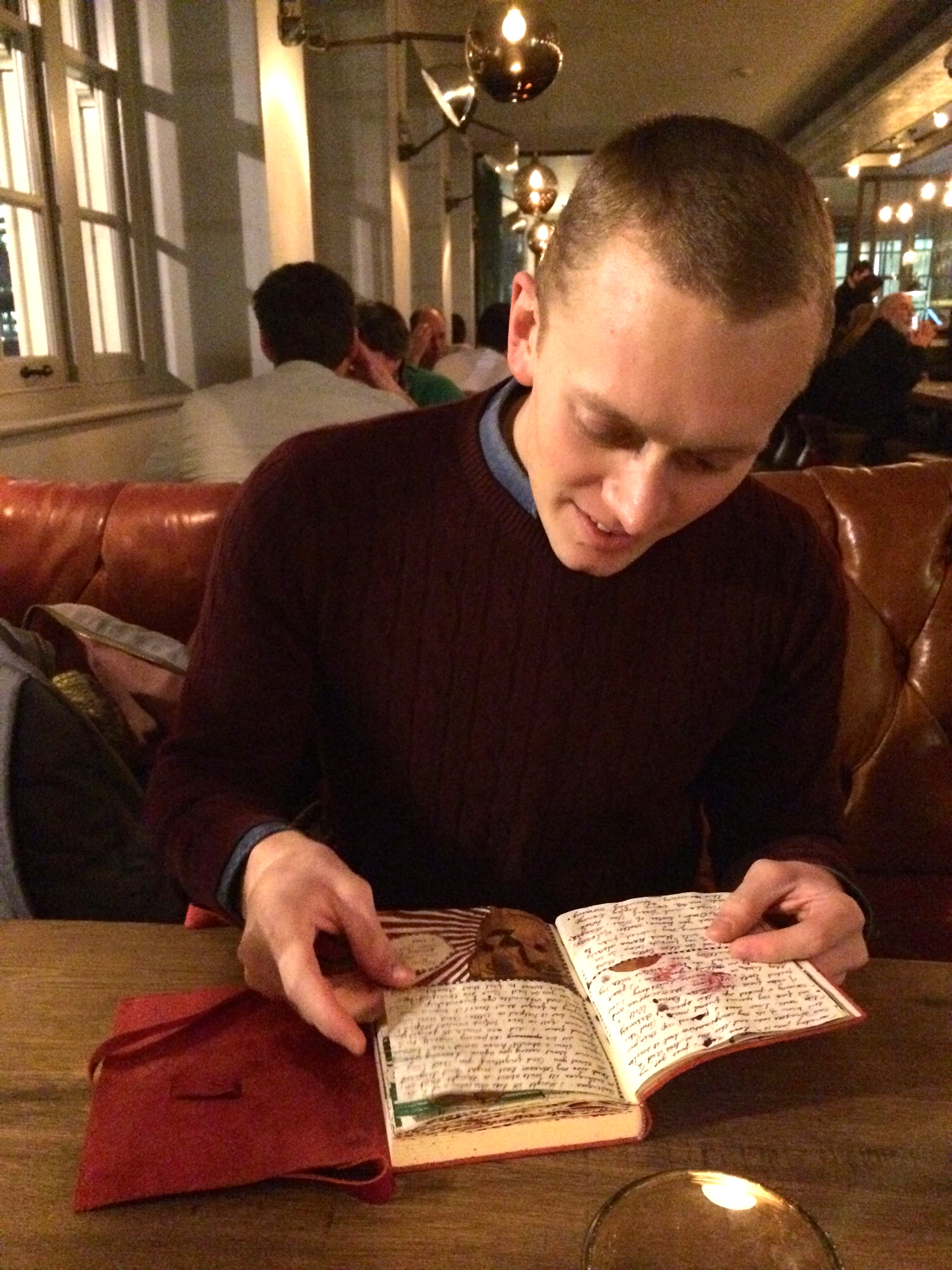 robert (or rob, bob or bobby) flips through my journal at the swan pub near shakespeare's globe theatre