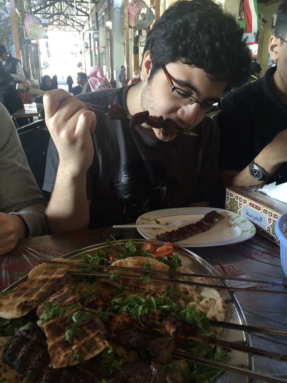khaled devours a skewer of cow meat