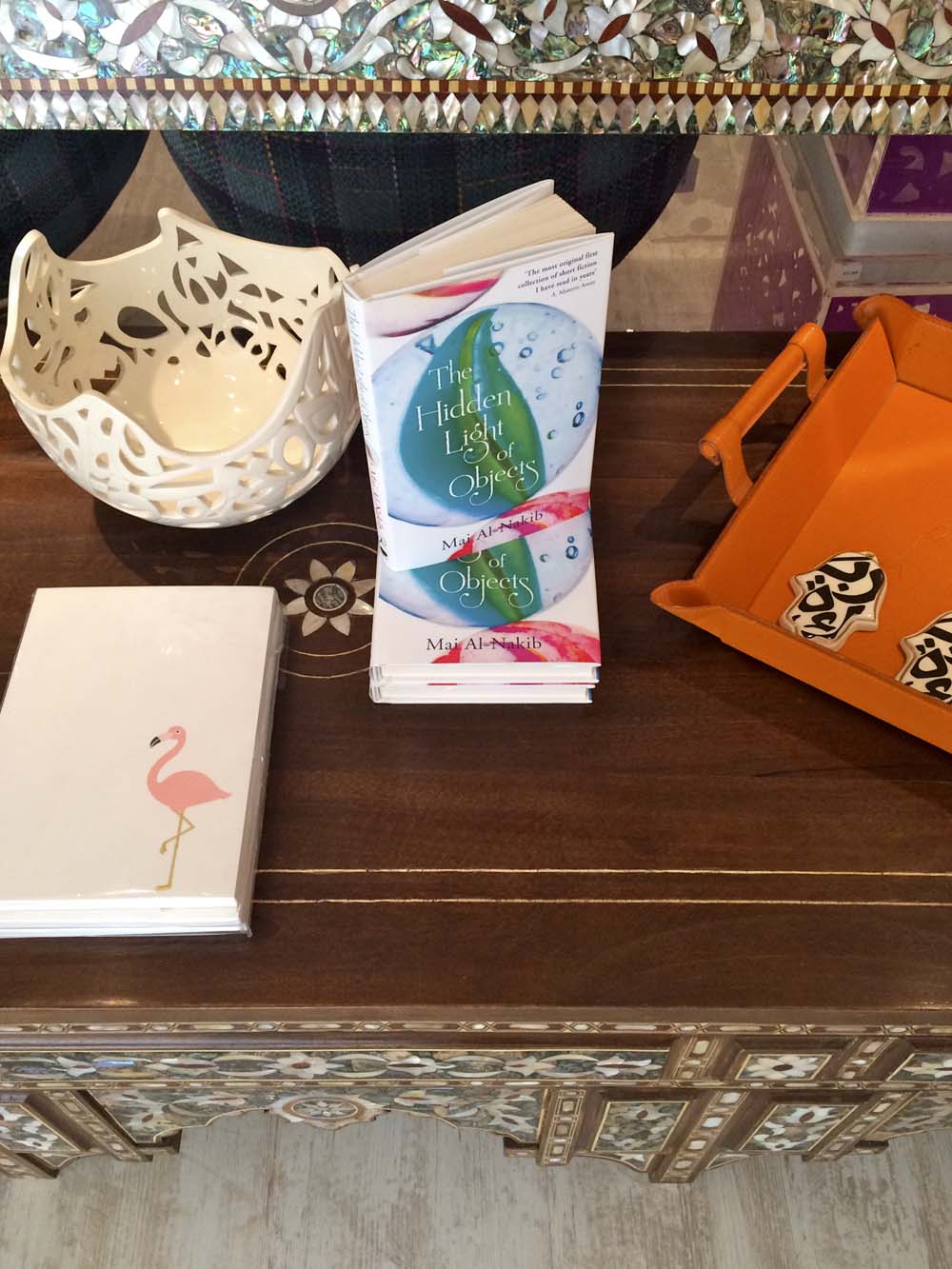 my dear friend mai al-nakib's book 'the hidden light of objects'. also an intricate ceramic piece and 'hands of fatima' by jordanian sculptor katia al-tal. and i love choux a la creme's quirky cards and notebooks, like the flamingo one here
