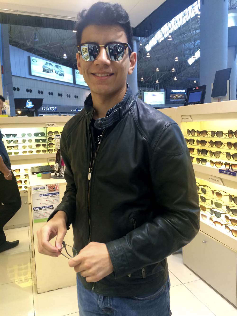 i was dropped off at the airport by my nephew tarek and my son yousef. it's so nice when roles are reversed and you feel like the little ones are now taking care of you. here yousef tries on a pair of aviators. joe cool