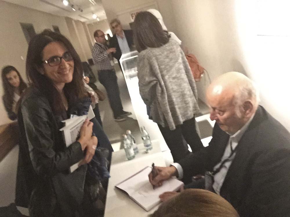 i lose my phone for a while so can't take any photos. luckily for me, laura's got hers. helmy el touni signs my copy of yasmine taan's book about his works